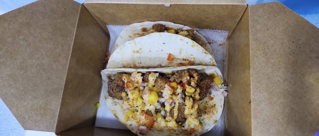 Folded Magic tacos in a takeout box